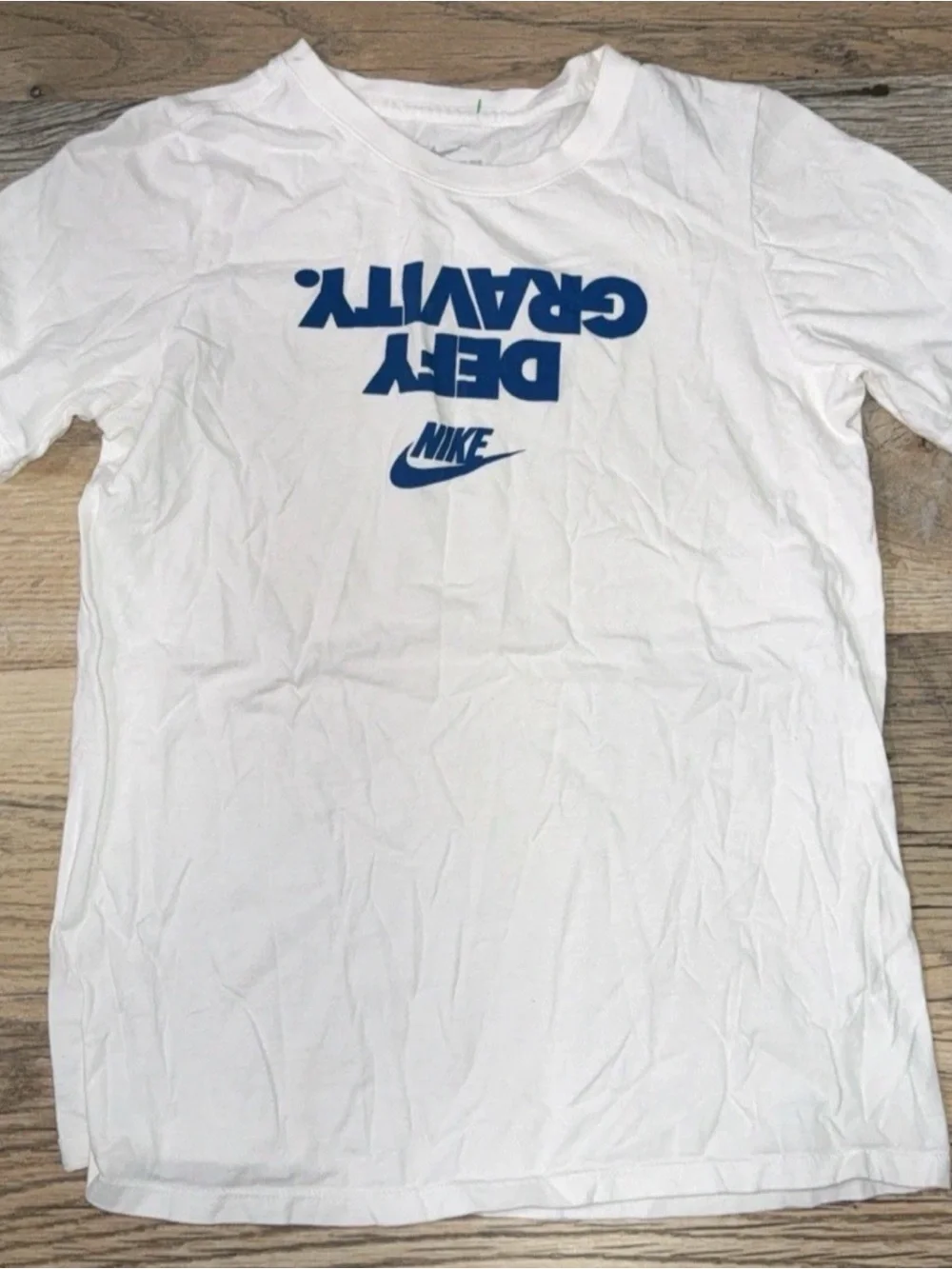 Nike White Tee with Blue 'Defy Gravity' Logo
